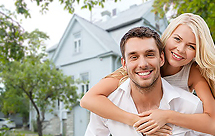 Young couple in front of a house